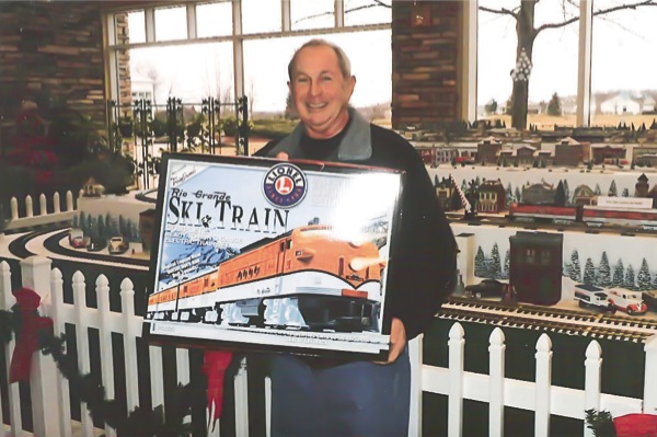 Caesar Baldacci, a winner of one of the three Rio Grande Ski Train sets, poses with his prize. Baldacci plans to give the set to his grandson. (Photo provided)