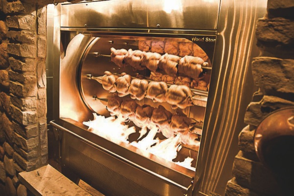 In addition to offering free s’mores, one of the special features of Niko’s Lodge in Algonquin Commons is the wood-burning rotisserie chicken fireplace, blazing more than forty whole chickens to perfect doneness in one of the primary dining rooms. (Photo by Chris LaPelusa/Sun Day)