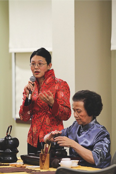 Angela Moy (left), of Wilmette, Ill. speaks while Jenny Wang (right), of Northbrook, Ill. demonstrates traditional tea preparation at Glenview Public Library on January 15, 2012. (Photo provided)