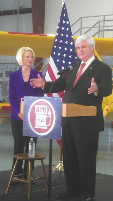Republican presidential candidate and former Speaker of the House Newt Gingrich stands with wife Callista Gingrich and speaks at the Lake in the Hills airport March 14. (Photo by Mason Souza/Sun Day)