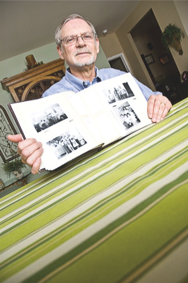 Sun City Resident Jim Rice displays his family photo album, which now holds pictures of his sister, brothers, and father. (Photo by Chris LaPelusa/Sun Day)