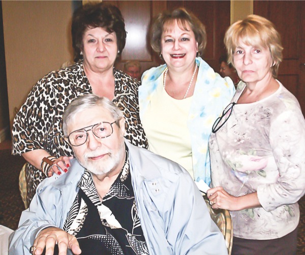 Peter Catsadimas, front, poses for a photo with attendees of the Creekside Cookers’ May 17 meeting. Catsadimas presented Greek recipes like Lo Kaniko, a greek sausage and offered tastings for members of the group. (Photo provided)