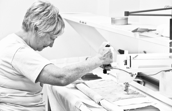 Sandy Miss of the Sew ‘N Sews, sews using donated fabric from Jan Hoeft’s store, Interior Motives. (Photo by Hannah Sturtecky/Sun Day)