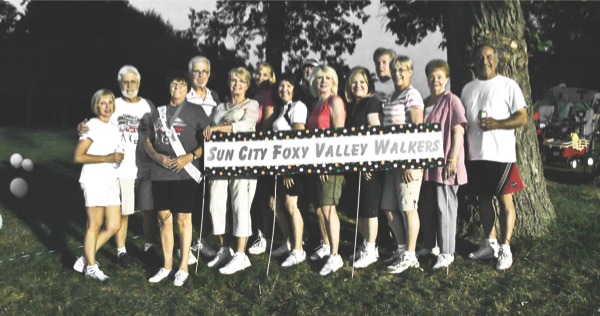 Members of the Sun City Foxy Valley Walkers pose for a photo during the 2012 Relay for Life of Northern Fox Valley, held in Huntley’s Deicke Park. (Photo by Hannah Sturtecky/Sun Day)