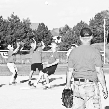 Players gather to catch a fly ball during the Sun City Softball League’s annual all-star game, played on August 7. Players from the American Division won the game 15–2. (Photo by Hannah Sturtecky/Sun Day)