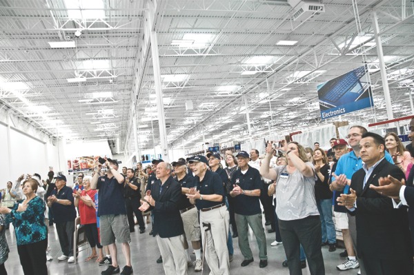 Those in attendance at Sam’s Club grand opening ceremony in Elgin cheer as the American and Illinois state flags are unveiled inside the new store. (Photo by Mason Souza/Sun Day)