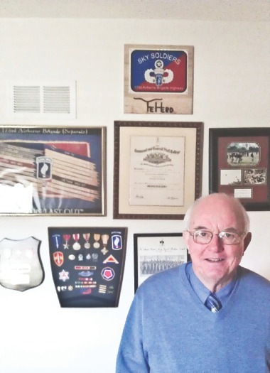 Robert “Ragman” Getz, candidate for Kane County Board District 22, stands before his military honors. Getz served two tours of duty in Vietnam with the Army. (Photo by Mason Souza/Sun Day)