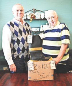 Jerry LaBonte (left), N.12, along with Jack Gilhooly, founder of “Buck in the Boot,” show off the well known boot. (Photo by Rebecca Vazquez/Sun Day)