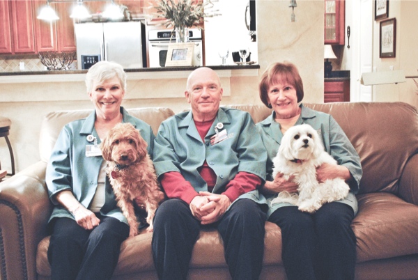 Bailey (left) and Sampson along with their owners Nancy and Don Griffith (left, middle) and Judy Engeriser (right) visit with patients at Sherman Hospital to help on their road to recovery. (Photo by Rebecca Vazquez/Sun Day)