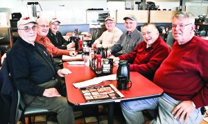 The Aviation Club and its members Ed Gunderson (bottom left), Michael Birosak, Vince Lynn (top left), Gerrit Plantinga (top right), Jerry Grimmonpre, Harry Sorenson and Steven Agnning (bottom right) gather for a weekly meeting at Country Pride Restaurant like they do every Thursday morning. (Hannah Sturtecky I Sun Day Photo)