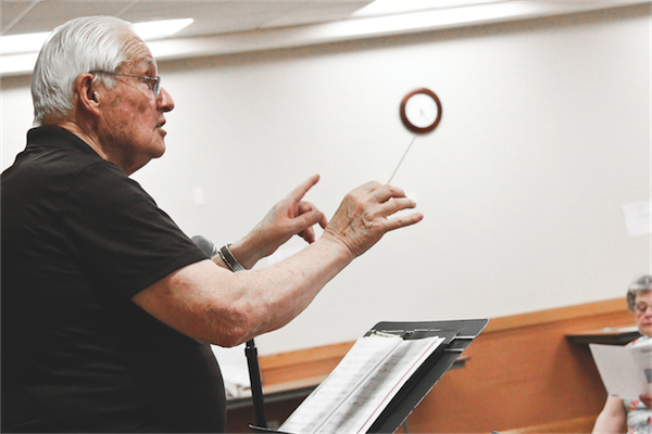 Prairie Singers Director, Bill Leggee, directs the group through one of their weekly rehearsals on Tuesday, May 27. “It’s hard to get 70 people to sing in tune and on time and still sound good,” said Leggee. (Photo by Hannah Sturtecky/Sun Day)