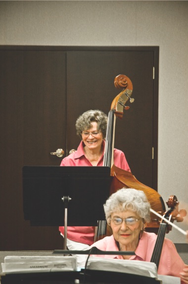 String bassist Carole Byrne (back) and cellist Jo Broz (front) rehearse with the Encore Chamber Orchestra. (Sun Day File Photo)