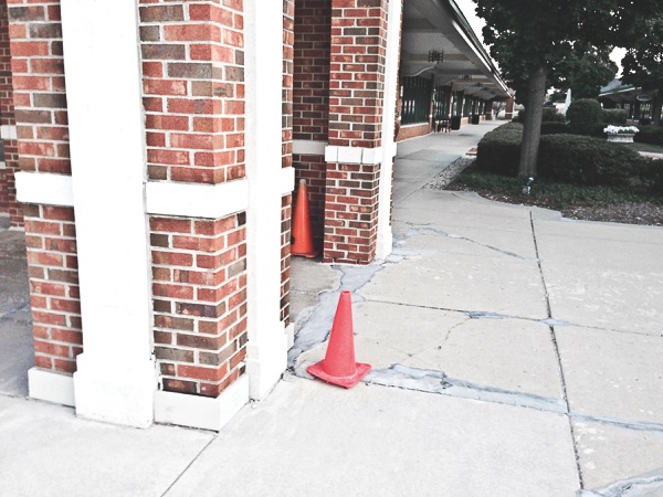 The cracked and uneven sidewalk conditions shown here accounted for Maggie’s fall last year. (Photo provided)