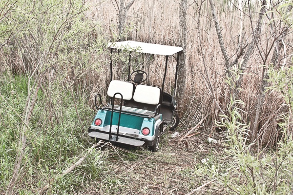 John Pape’s golf cart resting in the ravine behind the doctors offices on Regency Parkway after emergency crews rescued Pape from the accident. (Photo by Chris LaPelusa/Sun Day)