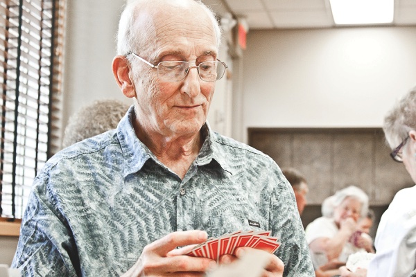 Dave Germaine plays cards at a recent round in the card room. (Photos by Chris LaPelusa/Sun Day)