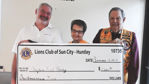 Sun City Lions: Lion Jim Graves, Grafton Food Pantry Director Jim Drendel, Lion Helen White.