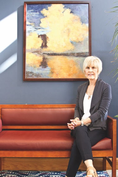 Laurel Sroka’s painting of the aftermath of a storm hangs in the fitness center’s entrance. Sroka’s painting is one of many works by Sun City residents now lining Prairie Lodge’s walls. (Photo by Chris LaPelusa/Sun Day)
