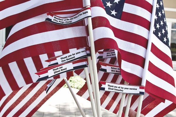 For a minimal donation, people can honor the after-the-fact vic- tims of 9-11 with a personalized flag, bearing the individual’s name. (Photos by Chris LaPelusa/Sun Day)