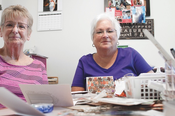 Marion Matthews (left) and Crafting Memories Club president Karen Czerwinski work on hundreds of Thanksgiving themed cards for this year’s shipment. (Photos by Chris LaPelusa/Sun Day)
