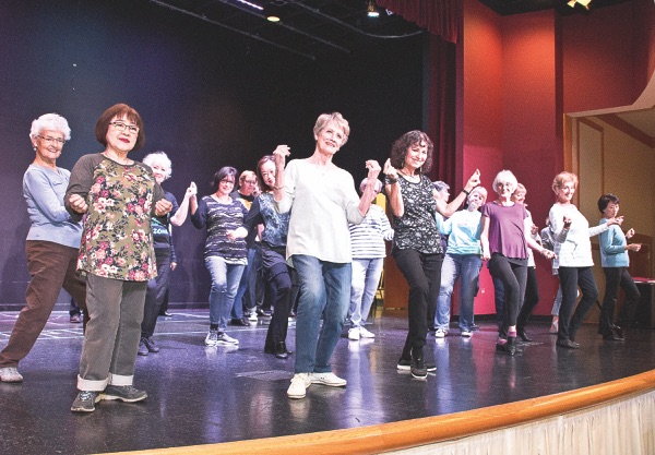 Female cast performs a dance routine at a recent rehearsal.