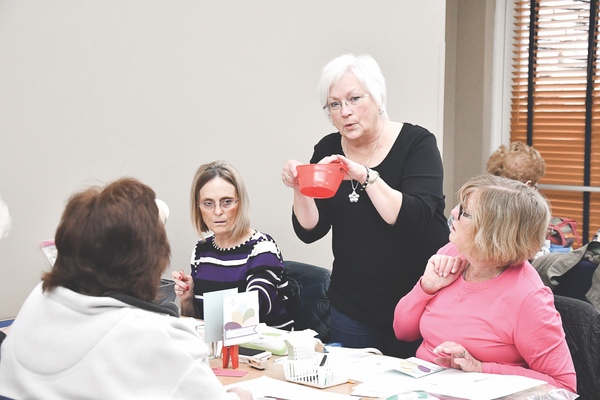 Karen Czerwinski’s gives hands-on help at her card-making class in Sun City. (Photo by Christine Such/Sun Day)