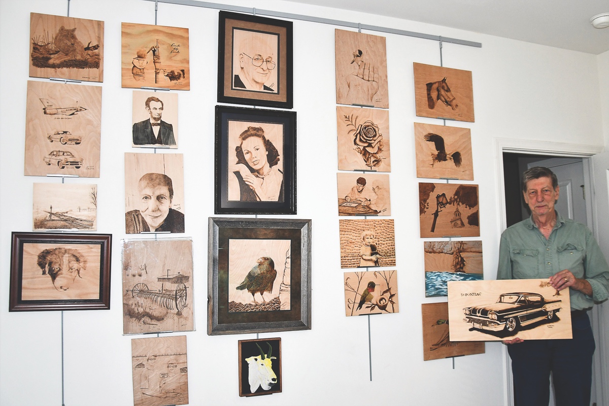 Part of Mosteig’s prolific gallery of pyrographic art on display in his Sun City home. (Photos by Christine Such/Sun Day)
