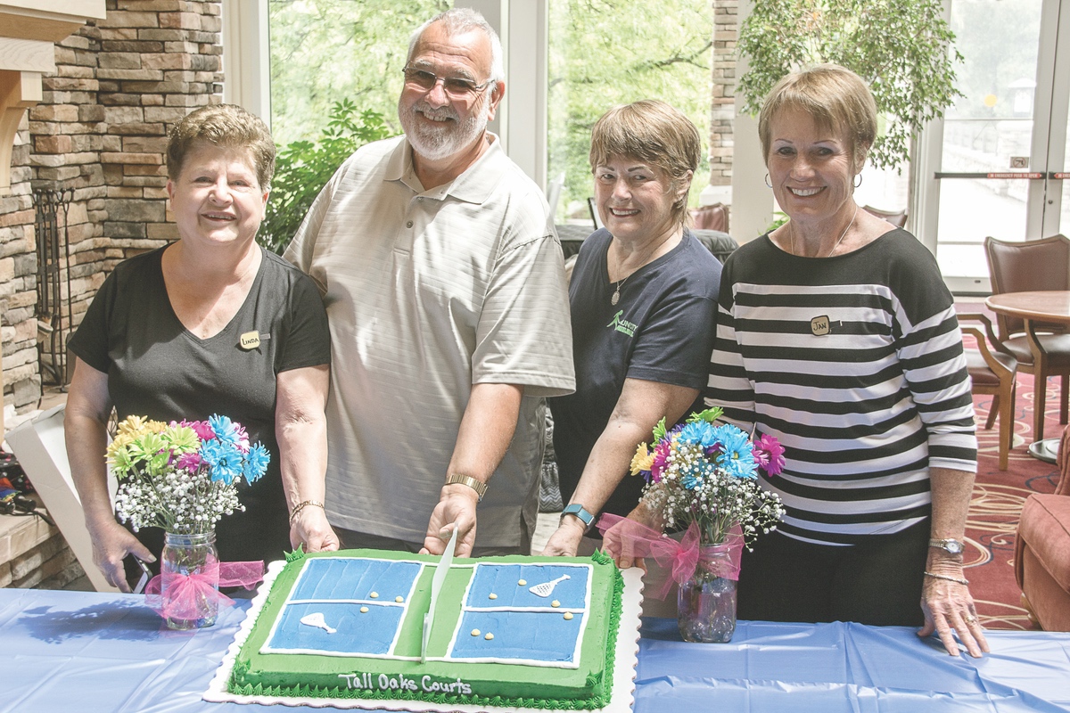 Club president is Lou Farinella and his officers (L to R) Linda Laux, Roni Schmidt, and Jan Robinson present a themed cake at the pickleball courts' recent grand opening. (Photo by Tony Pratt/Sun Day)