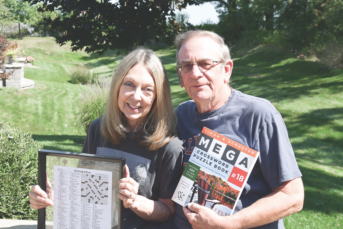 Kathy and Roger Weinberg are featured here, holding “Tea Times” in Times and the 2018 Simon and Schuster’s Annual Crossword Puzzle Books. (Photo by Christine Such/Sun Day)