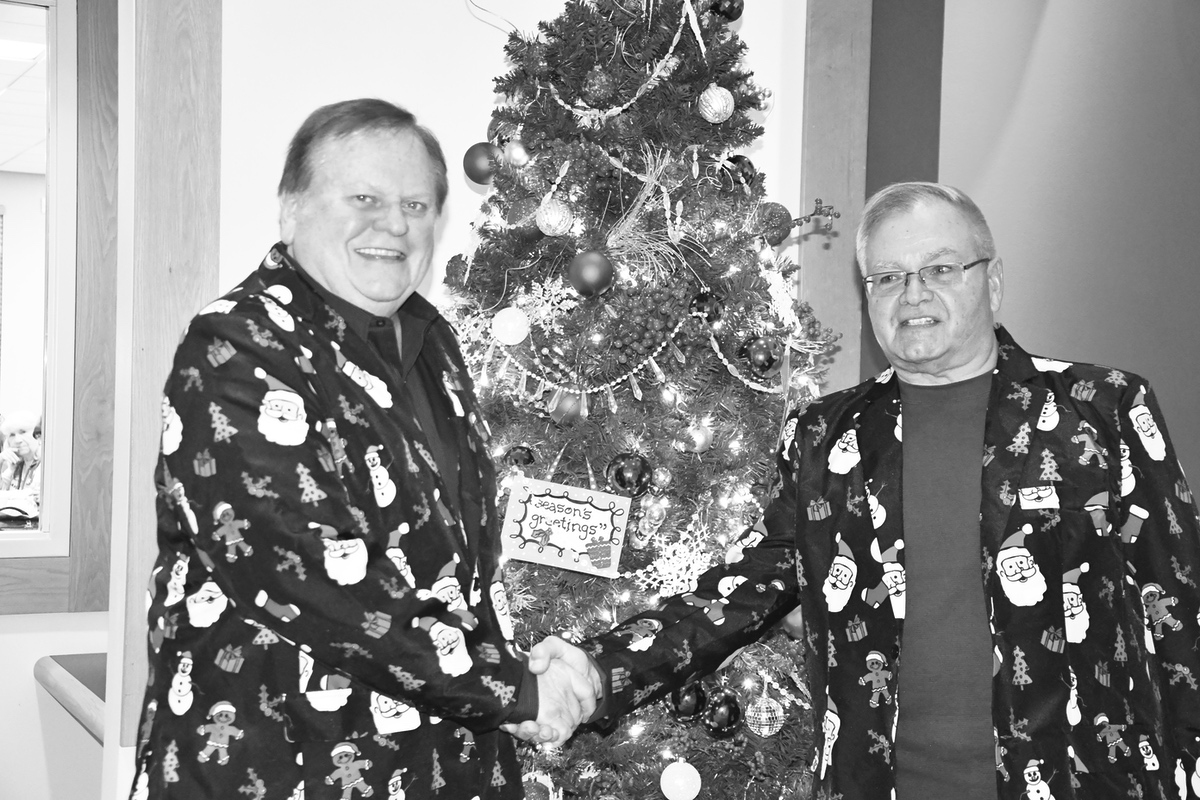 Kraig Klopfenstein (left) Mike Ptak (right). Klopfenstein and Ptak have reached the third stage of man according to Bob Phillips. "There are three stages of man: he believes in Santa Claus; he does not believe in Santa Claus; he is Santa Claus.” (Photo by Christine Such/Sun Day)