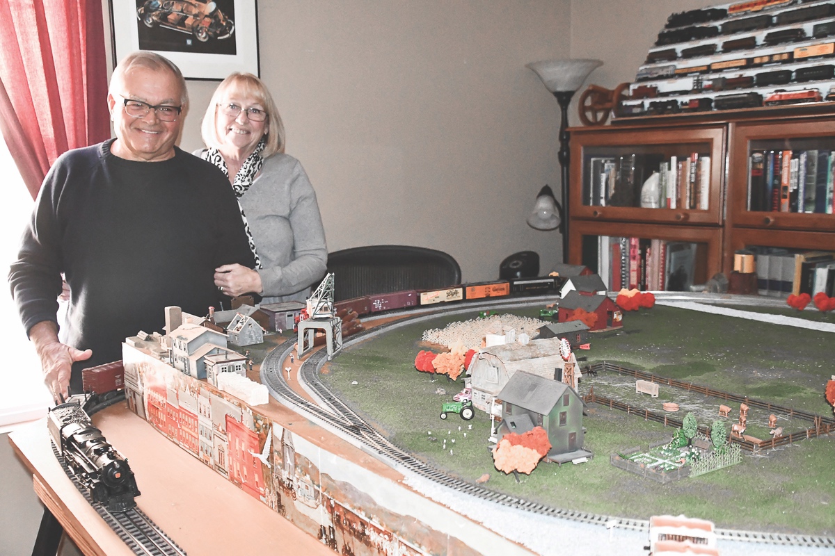 Mike Ptak has been a model-train enthusiast his entire life. With a group of friends and other enthusiasts, Ptak created and sold F.R.E.D.S. for models. F.R.E.D.S. are a rear, red light that replaced the caboose in life-sized trains. Ptak and his wife Cindy are featured here with his model railroad. (Photos by Christine Such/Sun Day)