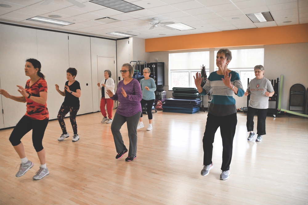 Nancy Jenkins (front, far left) leads the Balance Focus class in a step routine.