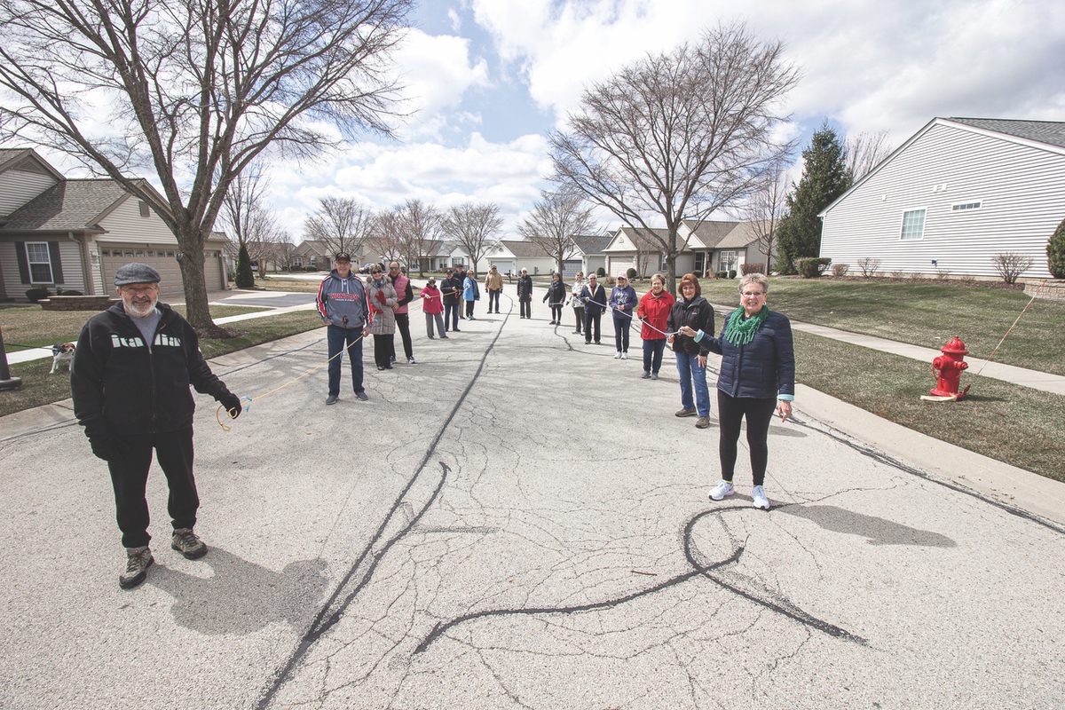 N18 walking group uses rope marked at six-foot lengths to adhere to social distancing guidelines while staying fit, during quarantine. (Photo by Tony Pratt/Sun Day)