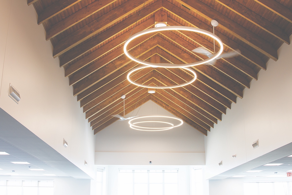 Library renovations feature ecofriendly lighting throughout, as seen here with the ringed lighting in the new fiction room. The circular theme is seen all through the updated library.