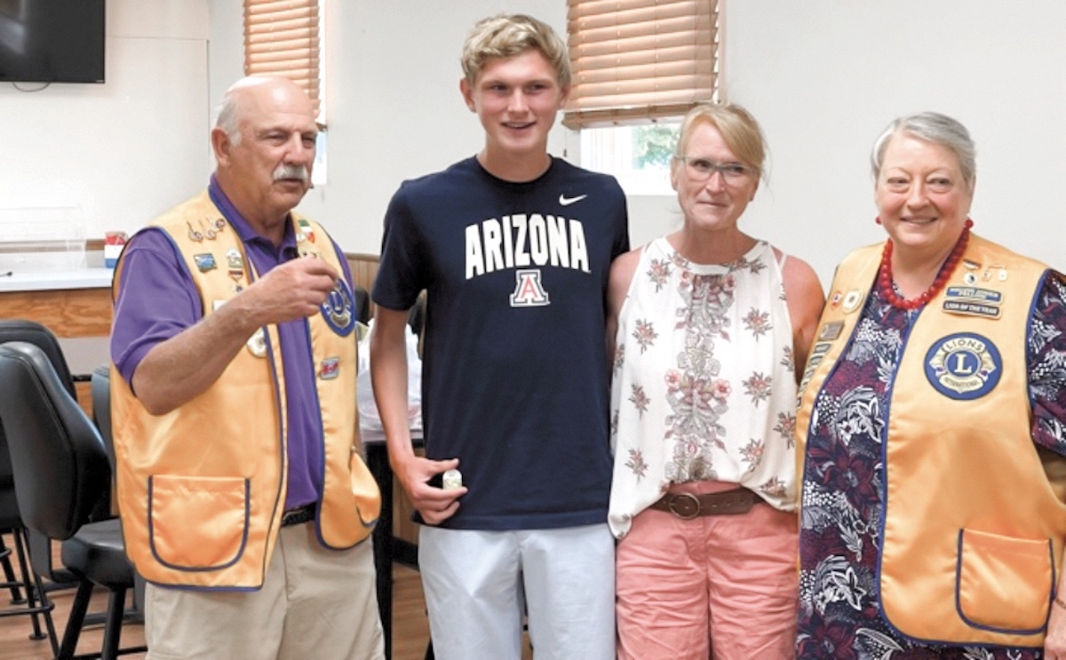 Scholarship winner Owen Cravens stands next to his mother Dede and Lions Club President Jim Saletta and Lions Secretary Carol Santee.