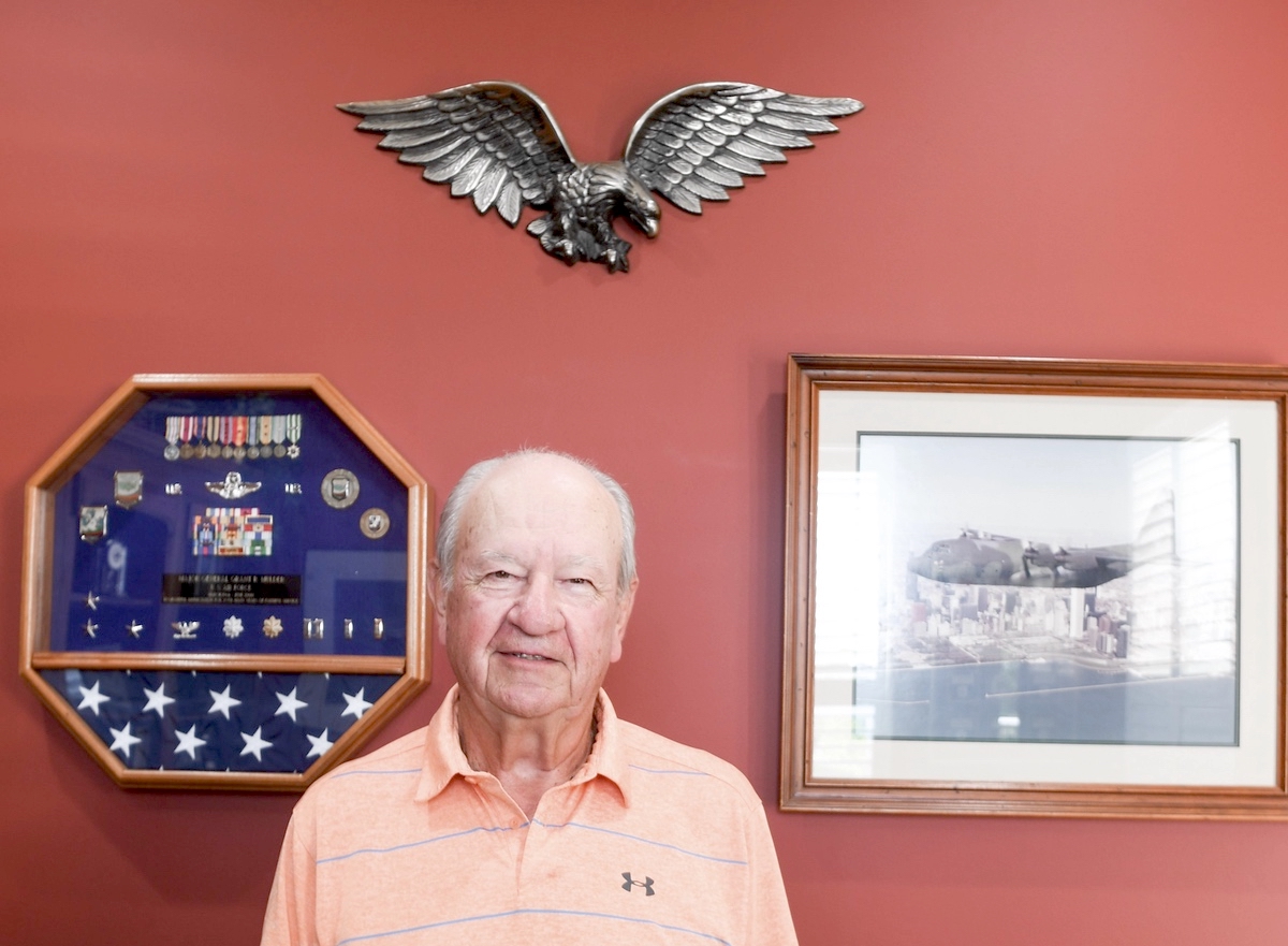 Grant Mulder poses with his medals and his favorite aircraft the C-130. (Photo by Christine Such/Sun Day)