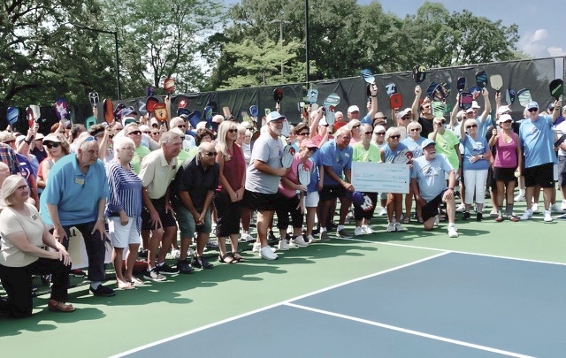 Approximately 200 members of the Sun City Pickleball Charter Club celebrate the retirement of the $30,000 load used to build eight Pickleball courts at Sun City. The $11,843 check paid off the balance of the debt 2 years in advance of its due date. (Photo by David Goode/Sun Day)