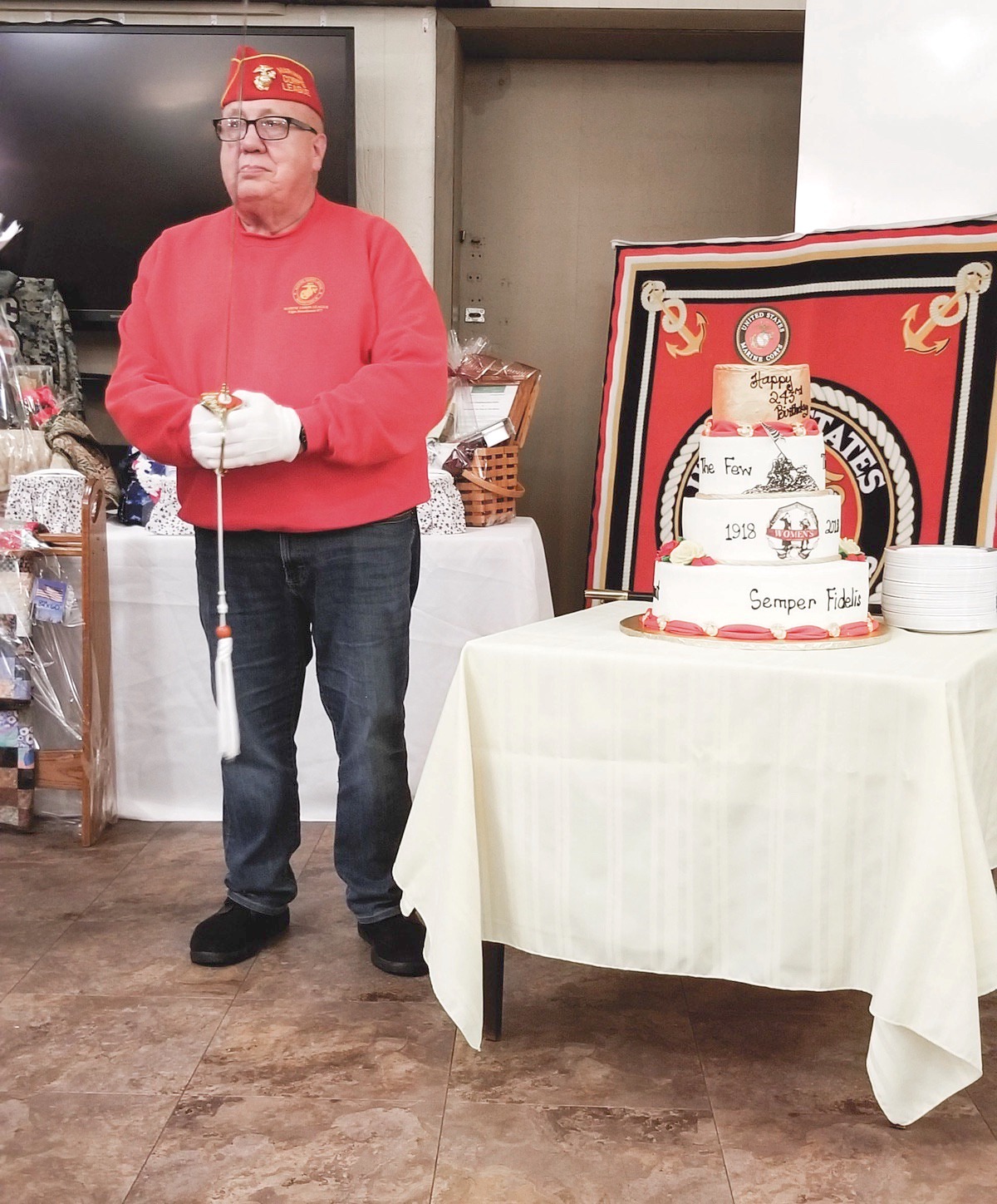 Commandant Fred Zimmermann of the Elgin Marine Corps League stands with a traditional Marine Corps birthday cake and sword to cut the cake. (Photo provided)