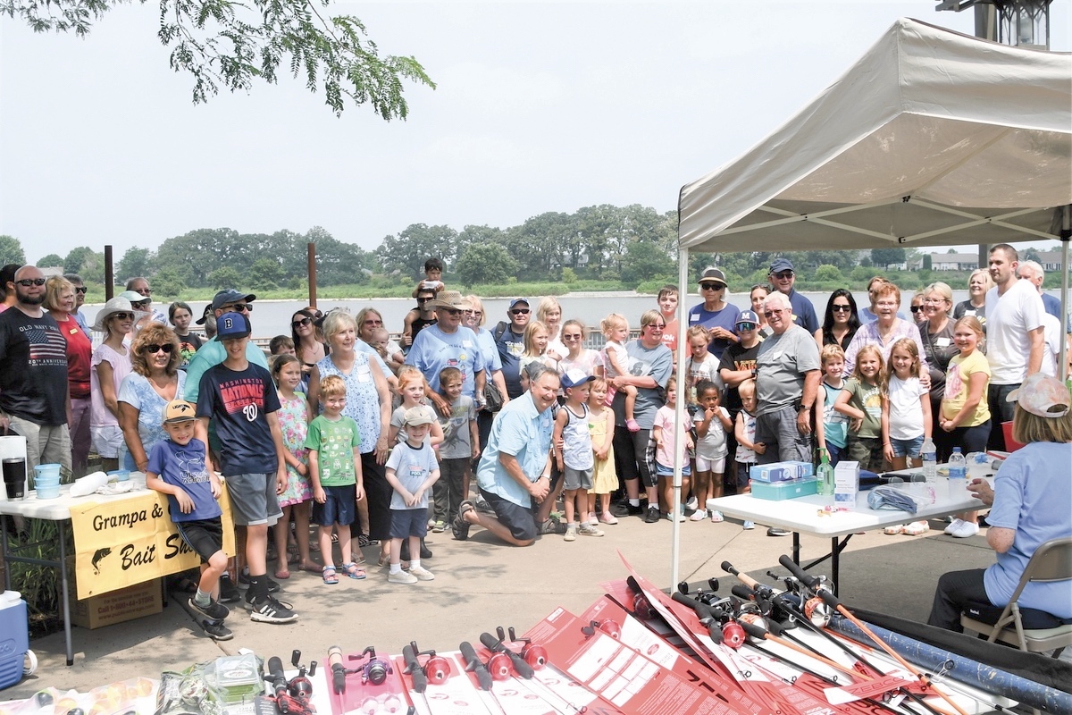 Anglers pose with grandparents and grandkids at a fishing derby. (Photo by Christine Such/My Sun Day News)