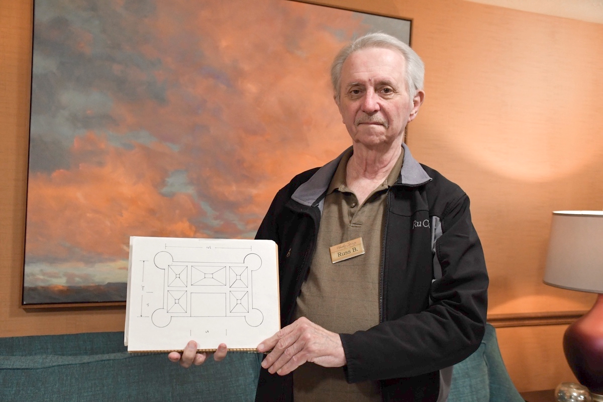 Russ Becker holds the original blueprints for his castle. (Photos by Christine Such/My Sun Day News)