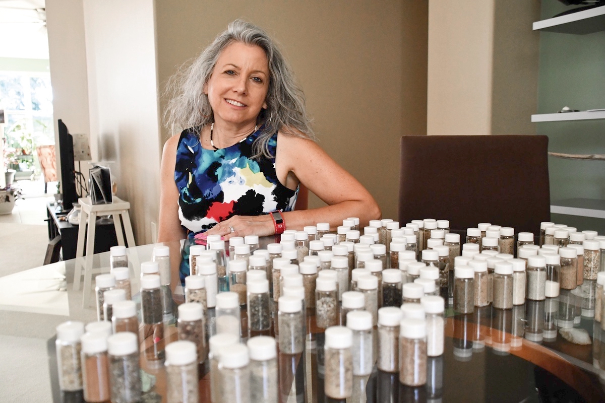 Kari Freeman displays her extensive sand collection. (Photo by Christine Such/My Sun Day News)