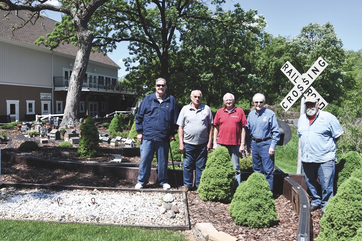 Model Railroad Club members (L to R) Jim Thomas, Vice-President, Alan Schrader, Richard Stolarczyk, Joe Vavra, Treasurer, Larry Rostis President stand before the outdoor G Scale train display that is in need of extensive repair. (Photo by Christine Such/My Sun Day News)