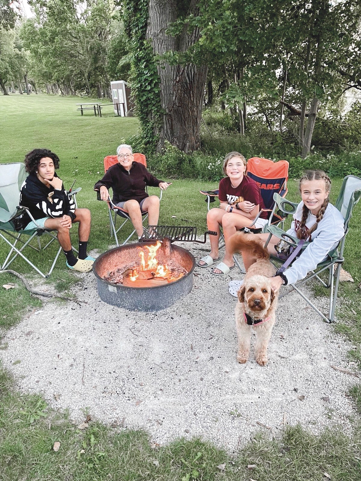 Esther Bell (second from right) enjoying a camping trip with her grandkids.