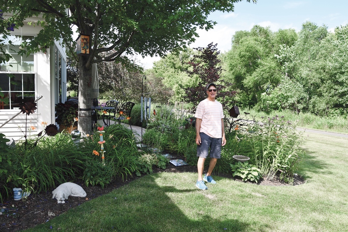 Artie Tepper with a stand of lillies by his home. Tepper has maintained lilly gardens since his first home on Long Island. (Photo by Christine Such/My Sun Day News)