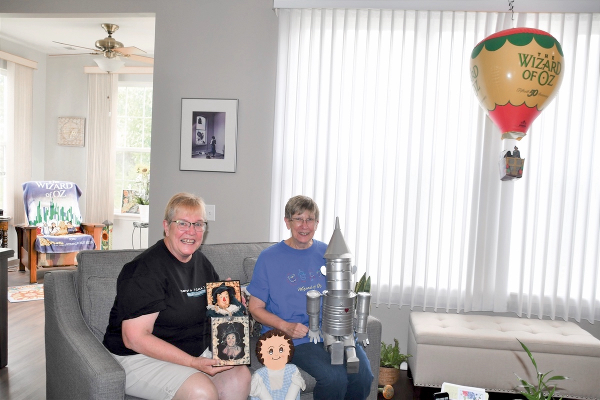 Sue Wallace (L) and Mary Schlee Hold some of their favorite Oz pieces. (Photo by Christine Such/My Sun Day News)