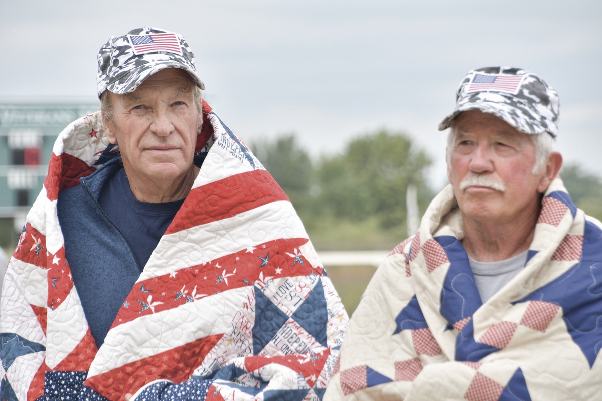 (L to R) Mike Hadjuk and John Pickleman received Valor Quilts from Gazebo Quilters Guild members Judy Manke and Catherin Ennis (not pictured) at the SC Softball Veterans Game. (Photo by Christine Such/My Sun Day News)