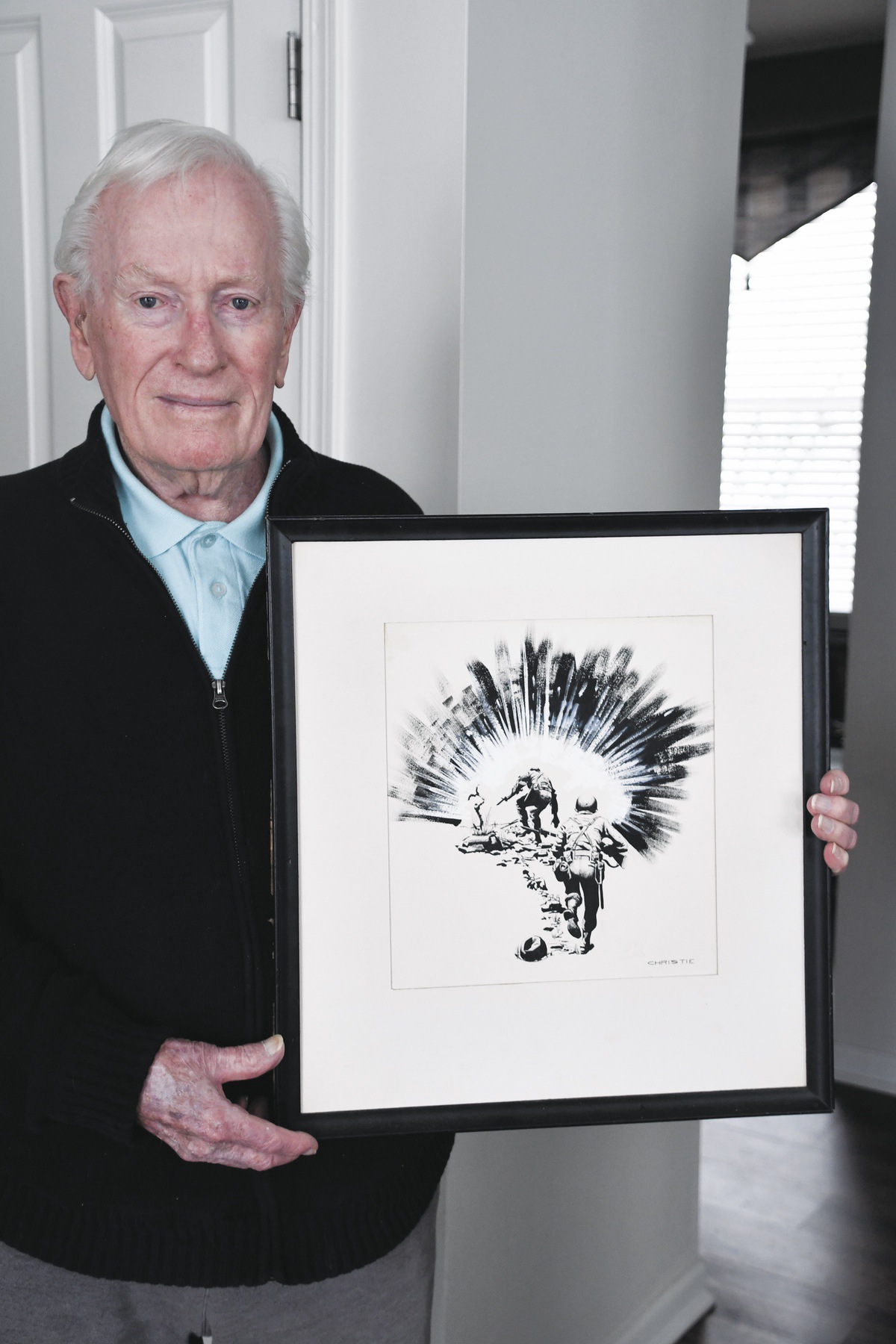 After his time in the Marines, Richard Christie, worked as an illustrator. Here he is with his illustrated photo for the WGN TV Series Men in War. (Photo by Christine Such/My Sun Day News)