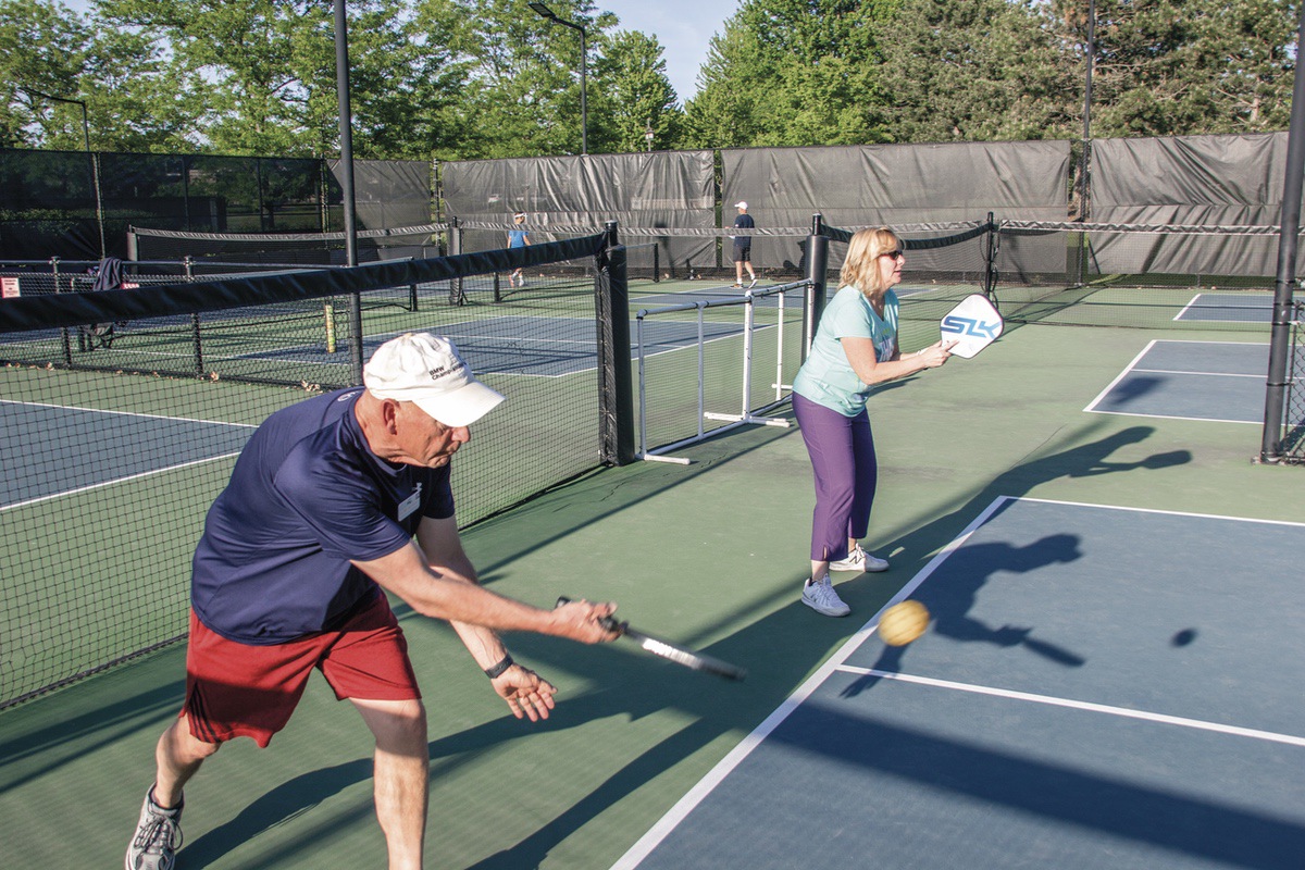 Pickleball player Ted Reffett, along with partner Diane Prank, returns a volley. (Photo by Tony Pratt/My Sun Day News)