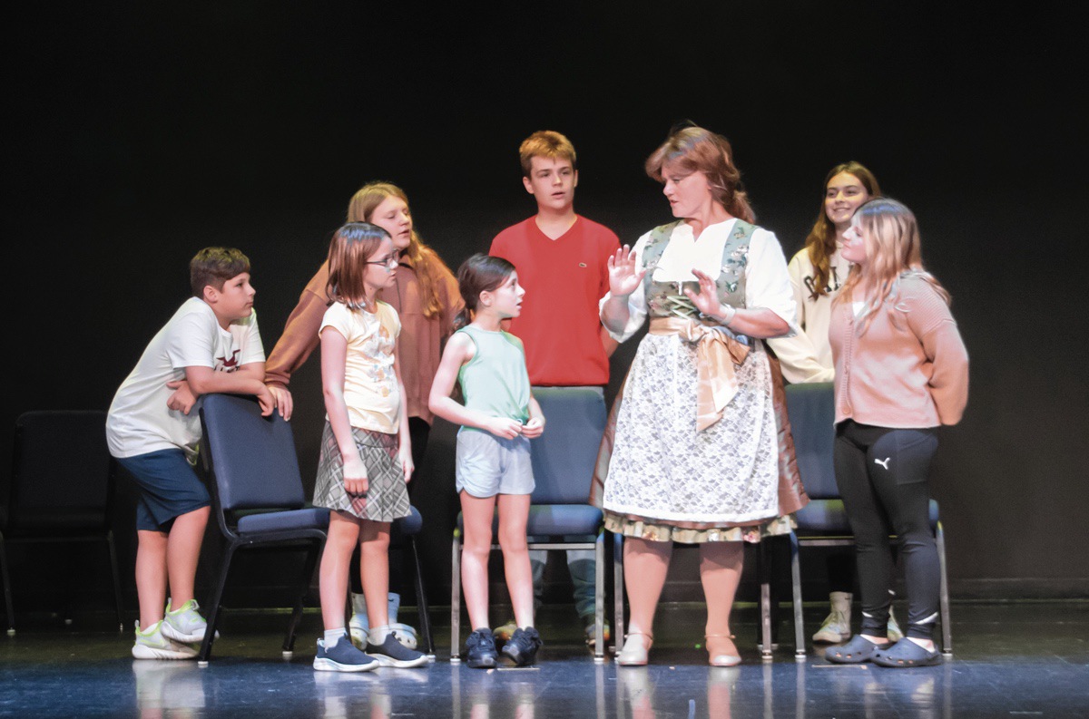Cynthia Church is seen here rehearsing with the child cast members. It’s been over a decade since the Theatre Company put on a show with a lot of child cast members.