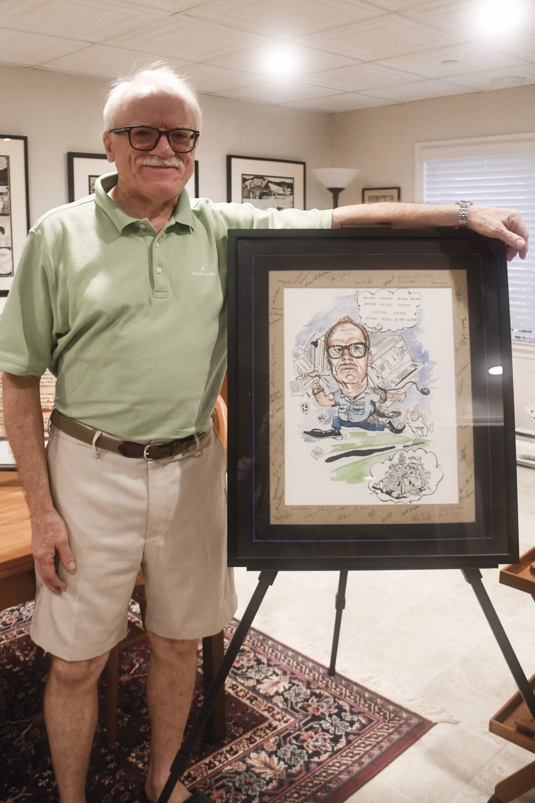 David Applegate is pictured here with a caricature drawing, depicting his dad’s work as a Cold War spy. (Photo by Christine Such/My Sun Day News)