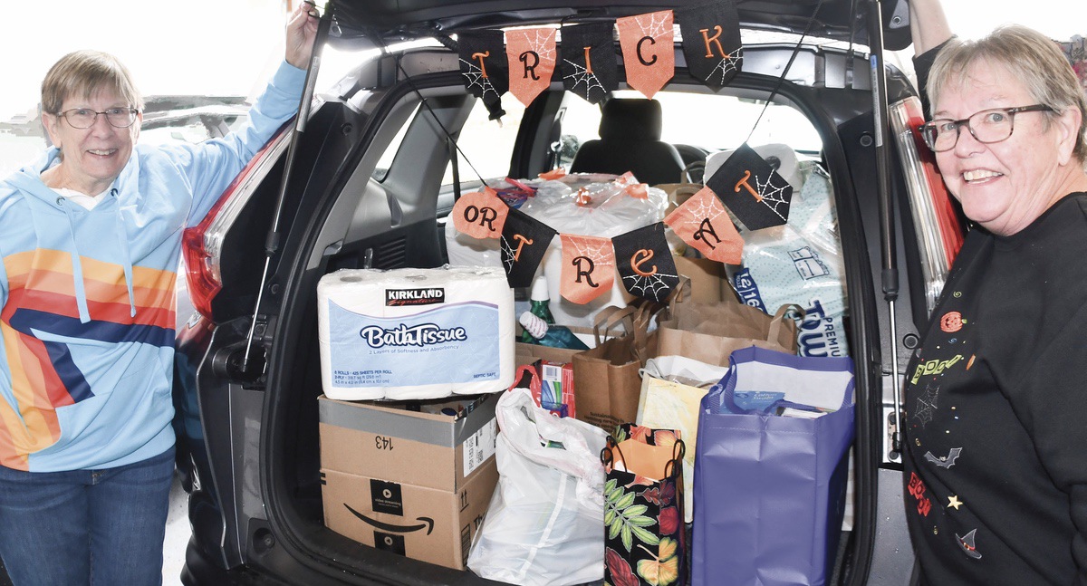 (L to R) Mary Schlee and Sue Wallace with their car filled with treats delivered to them for the Grafton Food Pantry. (Photo by Christine Such/My Sun Day News)